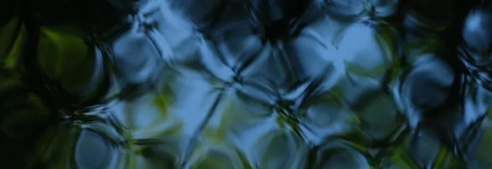 close up of geometric water pattern reflecting vibrant blues and greens