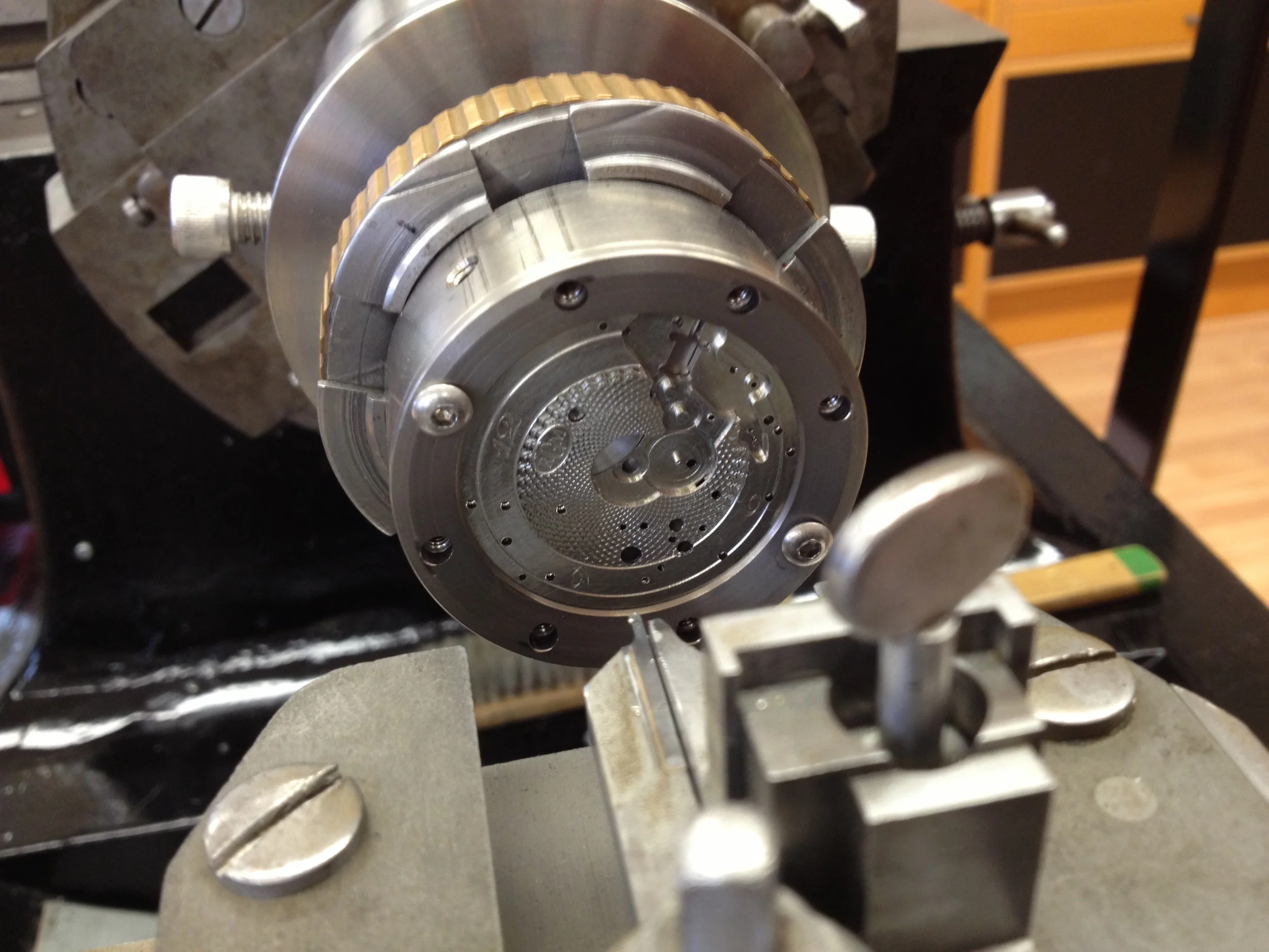  This clutch-looking contraption is called the rosette, and it's used to perform the painstaking task of applying Guillochè.&nbsp; 