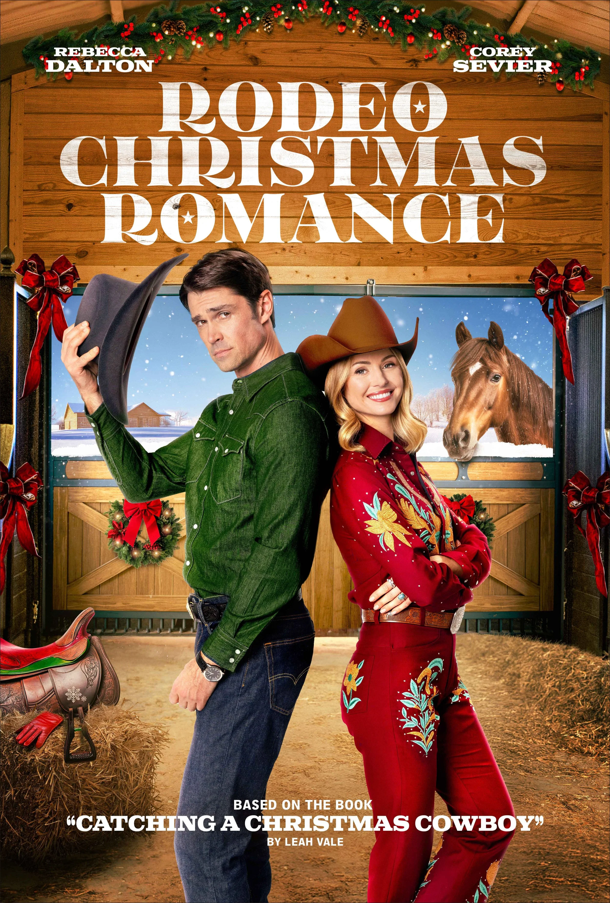 A promotional poster for 'Rodeo Christmas Romance,' featuring a man in a green shirt and a woman in a red embroidered cowboy outfit, standing back-to-back inside a barn with a horse peering out of a stall. The barn is decorated with Christmas ornamen