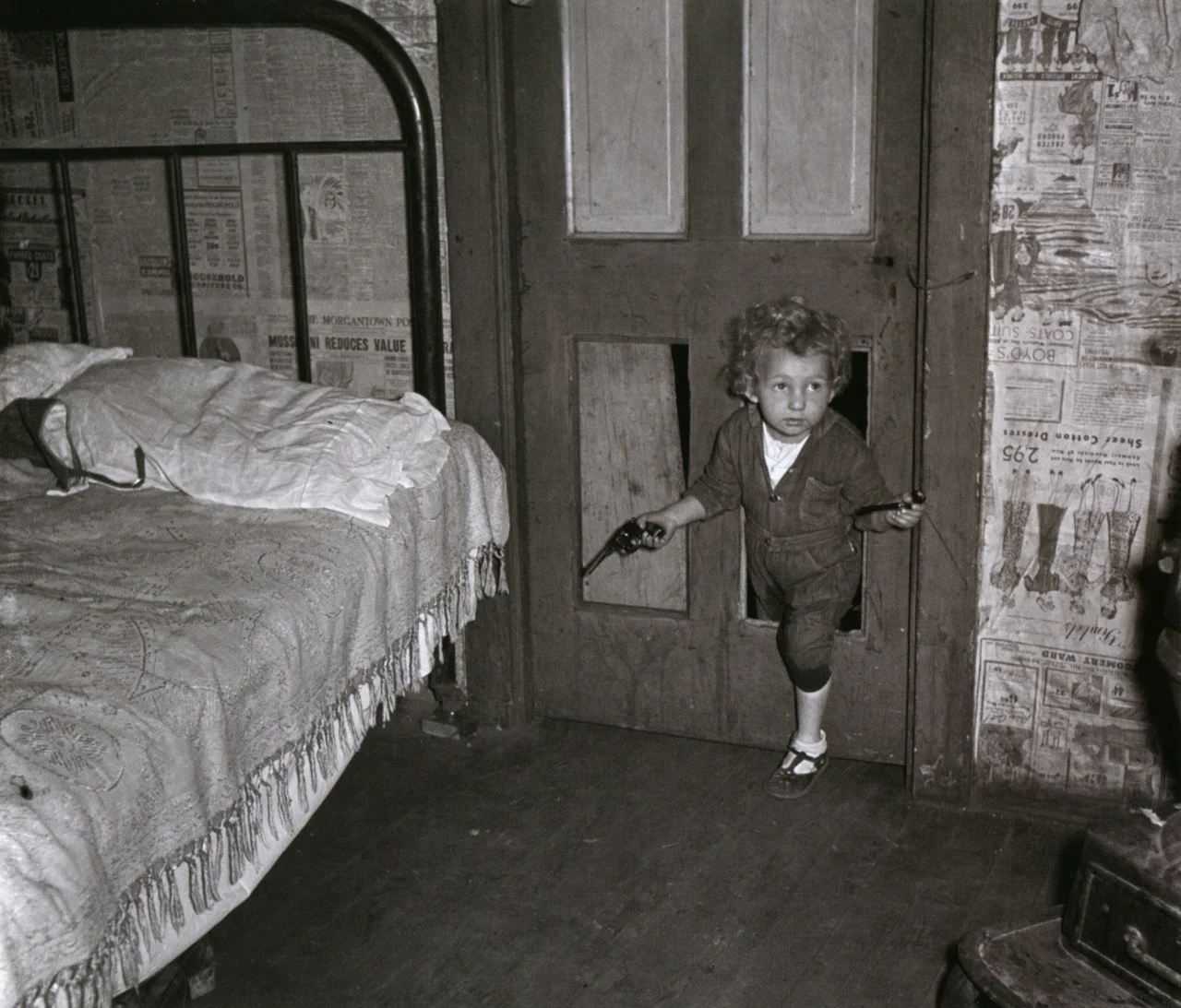 sealmaiden:

liquidnight:
Marion Post Wolcott - Coal miner’s child, holding a pipe in one hand and a gun in the other, uses the “cat hole,” Bertha Hill, West Virginia, September 1938
From Fields of Vision: The Photographs of Marion Post Wolcott