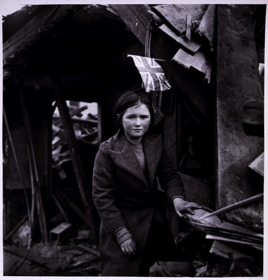 liquidnight:

Toni Frissell
Battersea incident, girl among the ruins and a British flag overhead, England, January 1945
[From the Library of Congress]
