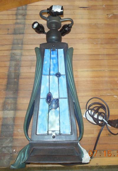 took in a Tiffany reproduction table lamp for replacement of art glass panes in the front panel and repairs to broken leg. Not rare or expensive but still in need or repair-1..jpg