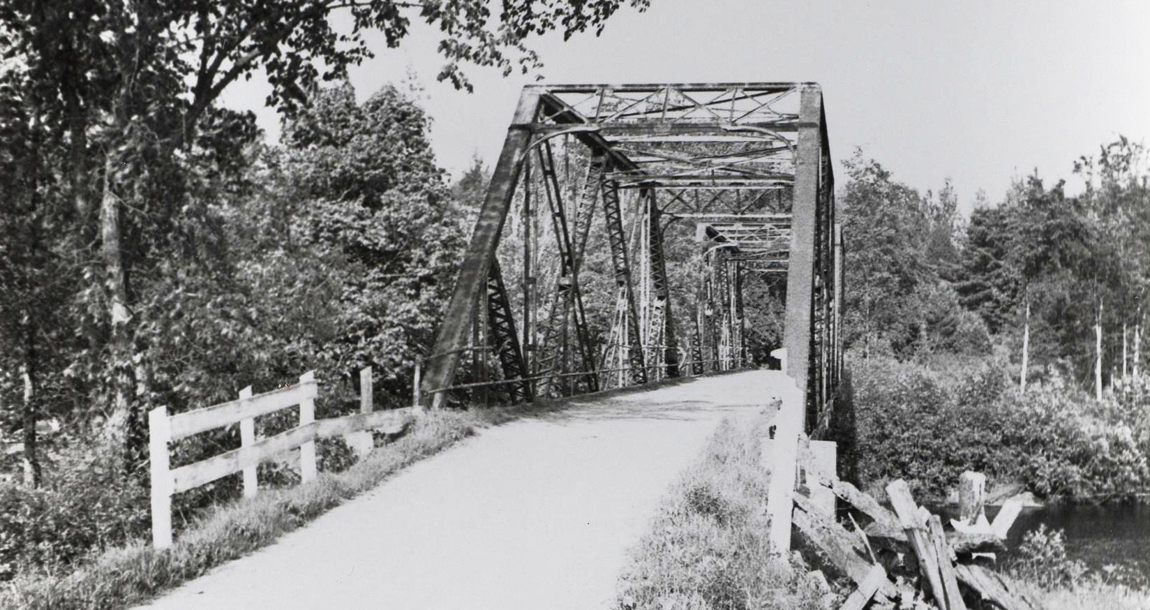 The Shanick Bridge - The iron bridge crossing Beaver Creek 9 miles north ofMarmora and generally called the Shanick bridge, was erected in the summer of 1912. It came in pieces to Marmora railway station, was hauled to the site by teams and wagons belonging to Gillam and Murphy and assembled on the spot. Mr. Ed O'Connor. recalls that Arthur Murphy used a team of Mr. O'Connor's to haul sand and gravel during the construction. On the first river drive in the spring of 1913, the logs jammed at the bridge and it was later raised three feet. At that time Shanick was a thriving farming community of 40-50 families. The bridge is still solid in spite of its age but in dire need of repairs and a paint job.