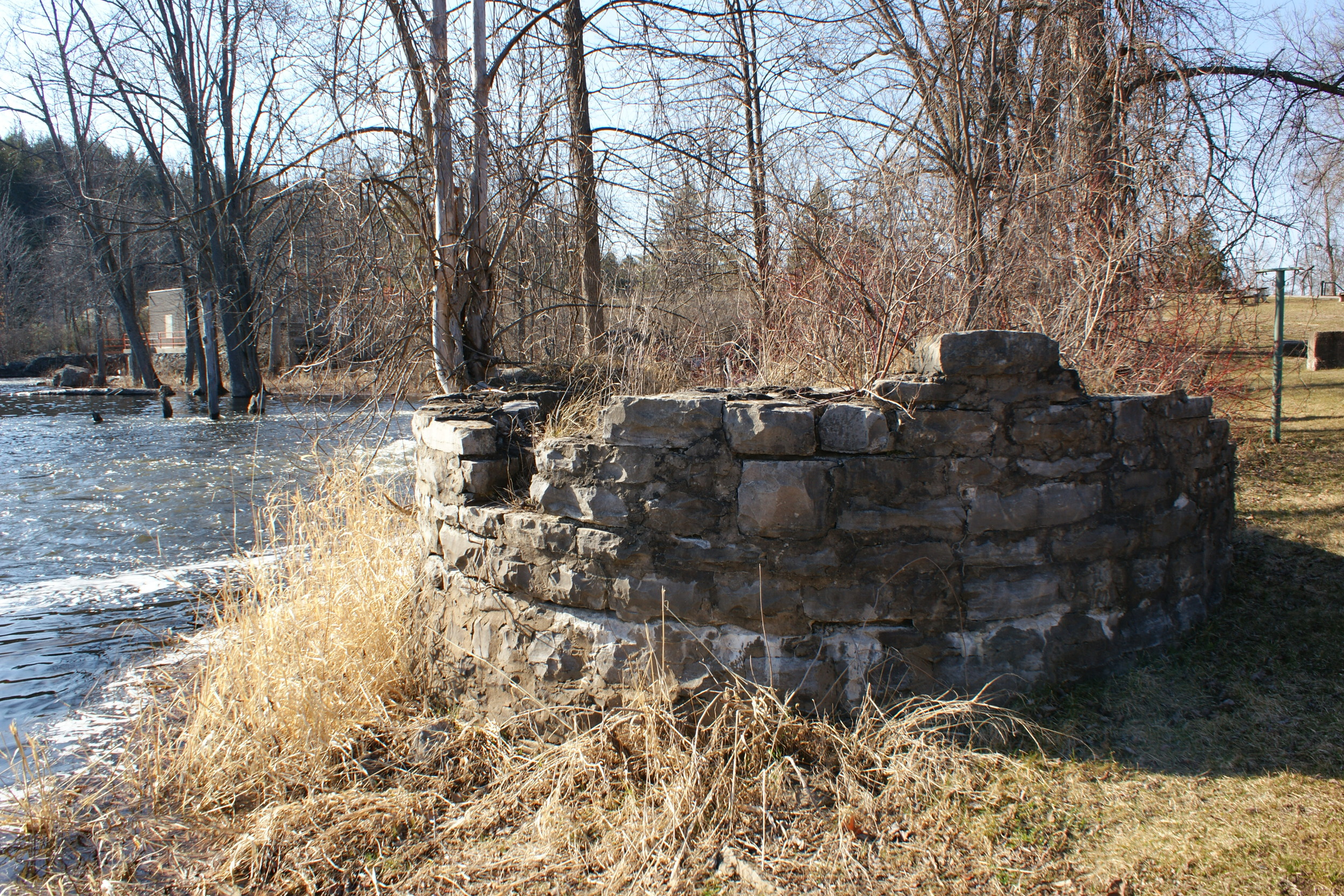 The Remains of the Pearce Empire The Pearce Company was the biggest business in town from 1873 until Nov. 30, 1933, when the last of its lands were sold off. All that is left of the vast spread of mill buildings at the dam are pillars and rock foundations that once held up a saw mill, grist mill, woollen mill, hydro generating plant and even a gold processing mill. Here, pictured, is the base of the gigantic sawdust burning chimney, easily visited at the dam.