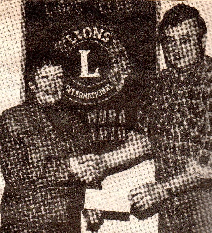 Dan bateman presents lions donation to town hall piano fund, accepted by wilma bush