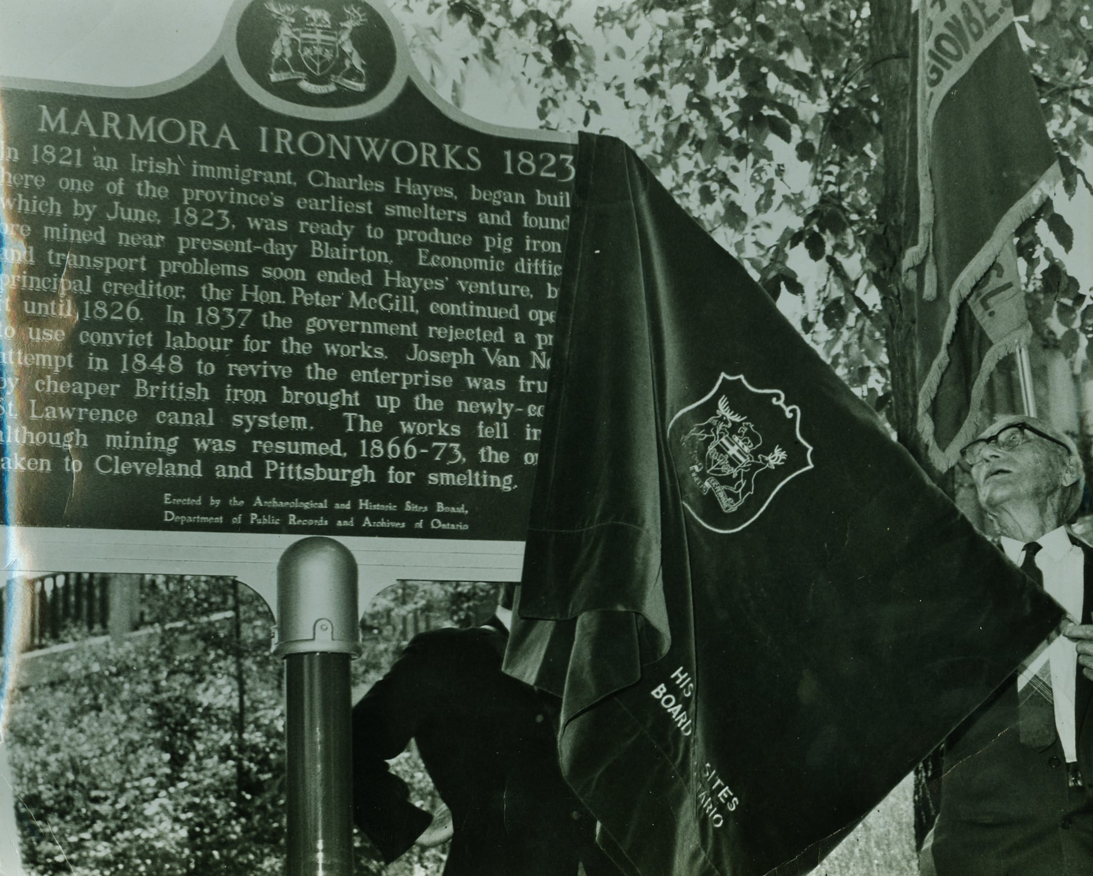 Ed O'Connor unveiling the ironworks plaque dedicated by the Ontario Heritage Foundation