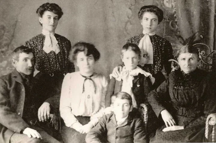 Jeremiah Legrow (far left) with his wife and family. Behind him and to the right is his daughter Catherine Sarah Legrow from his first marriage to Catherine Darrah (died in childbirth). 2nd wife Mary Ann Terrion far right, seated. Other two women daughters Mary Alberta (Bertha) Legrow and Theresa Legrow, and sons John and Harold Legrow. Suspected error in labelling. Boys are more likely to be sons of Theresa Terrions Mongraw- Fergus or Romeo. The fact that son, Reginald is not in the pictures, suggests it it pre-1914