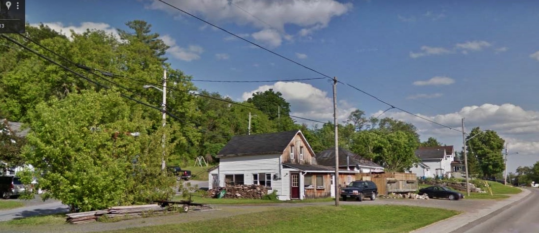 44 Main Street with gas pumps now buried in the bushes at the left