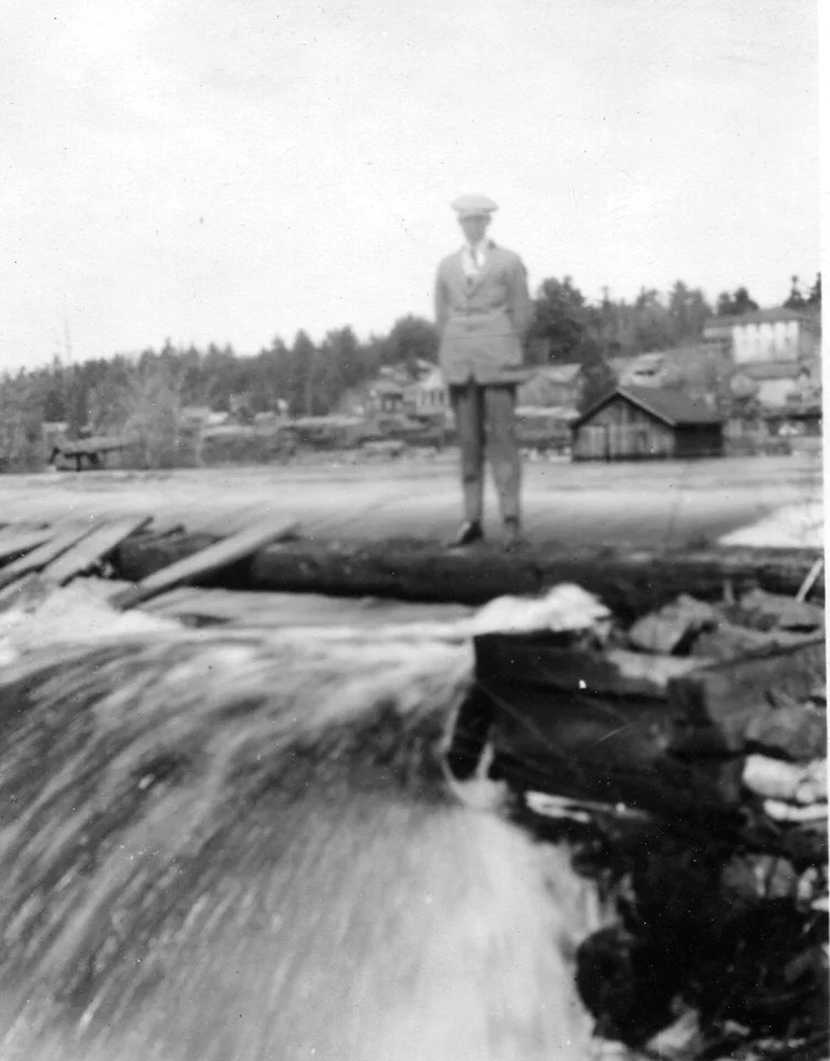 Ralph Neal standing on the dam when it ran parallel to the shore.