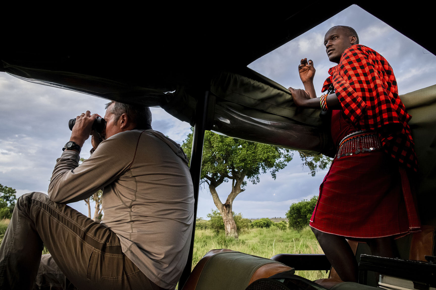 ESC’s CEO, Curt Vander Meer, sitting on top of a Jeep with binoculars looking for wildlife on a safari in the Masai Mara game reserve in Narok County, Kenya