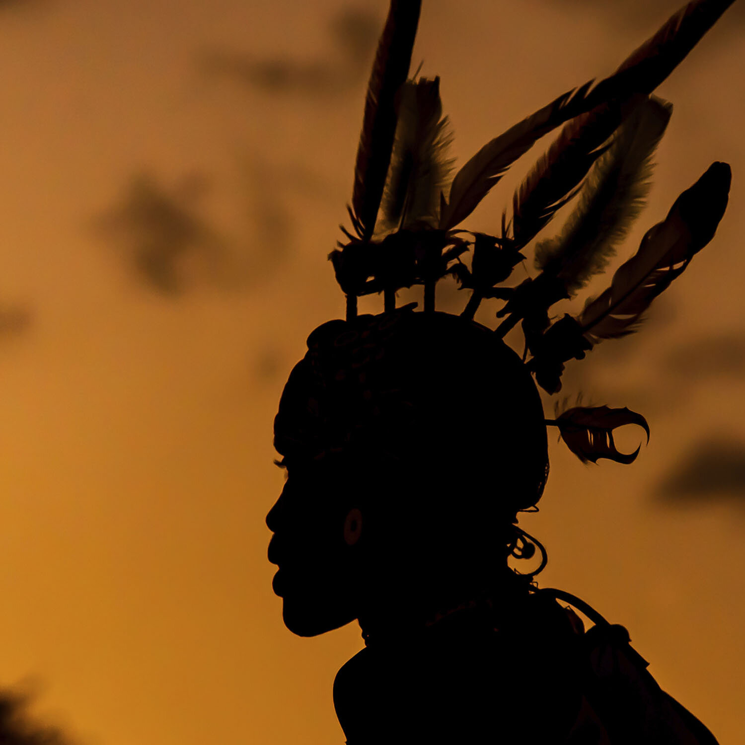 Silhouette of a Samburu Warrior in full dress at sundown at the Buffalo Springs National Reserve in Kenya