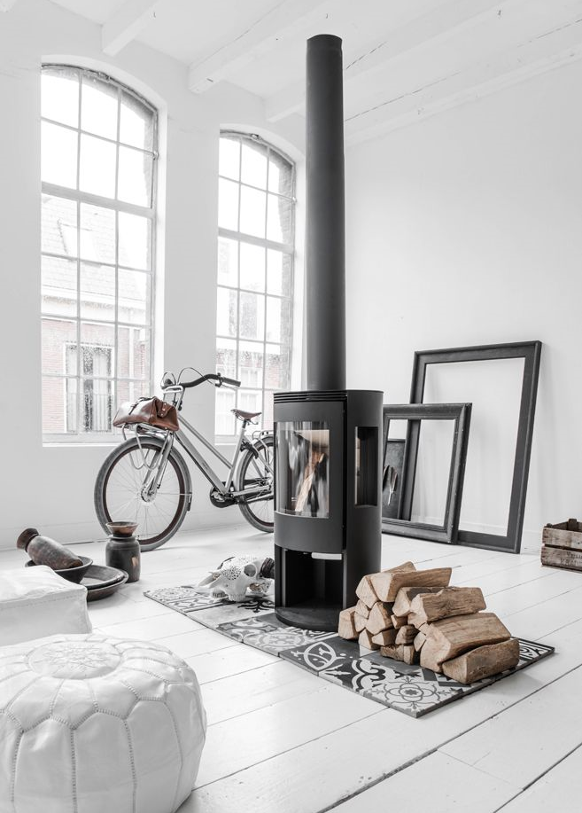 The idea of living in this loft space with these tall windows and a little fireplace. 