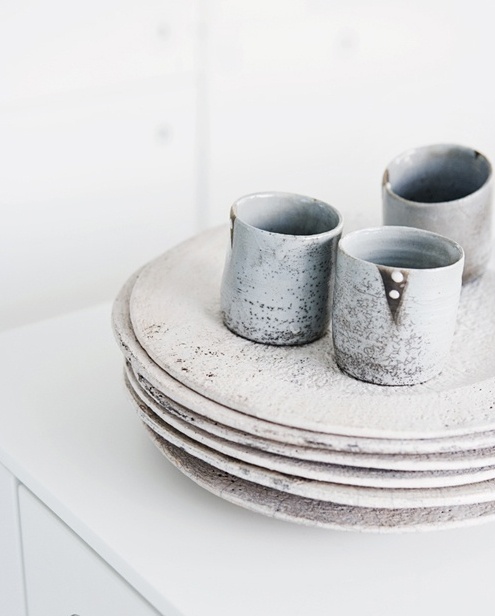 A beautiful set of ceramic tumblers and plates . 