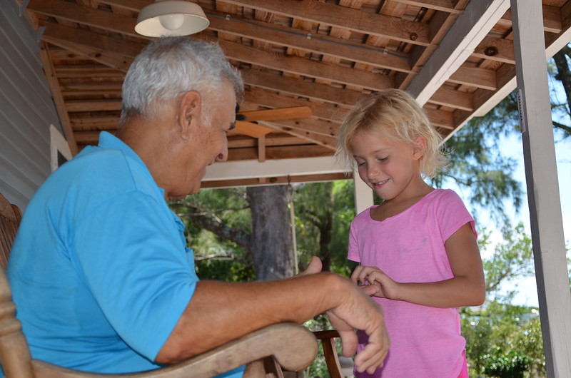 Camper Katherine Schwartzel listens to Ralph Woodring's shrimp boat stories. 
