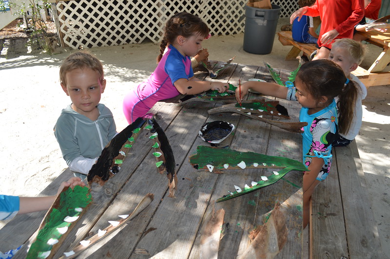 Gator Babies campers make their own "gator mouths" out of palm guards and seashells.