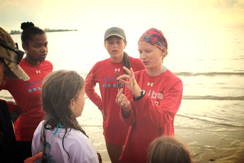 Counselor Nicole Finnicum teaches campers about marine worms at Bunche Beach. 