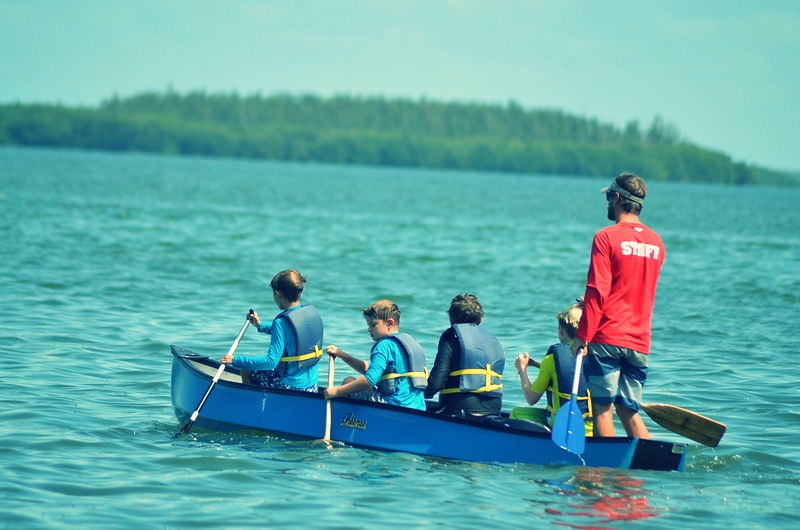 Calusa campers canoe in San Carlos Bay with counselor Mike. 