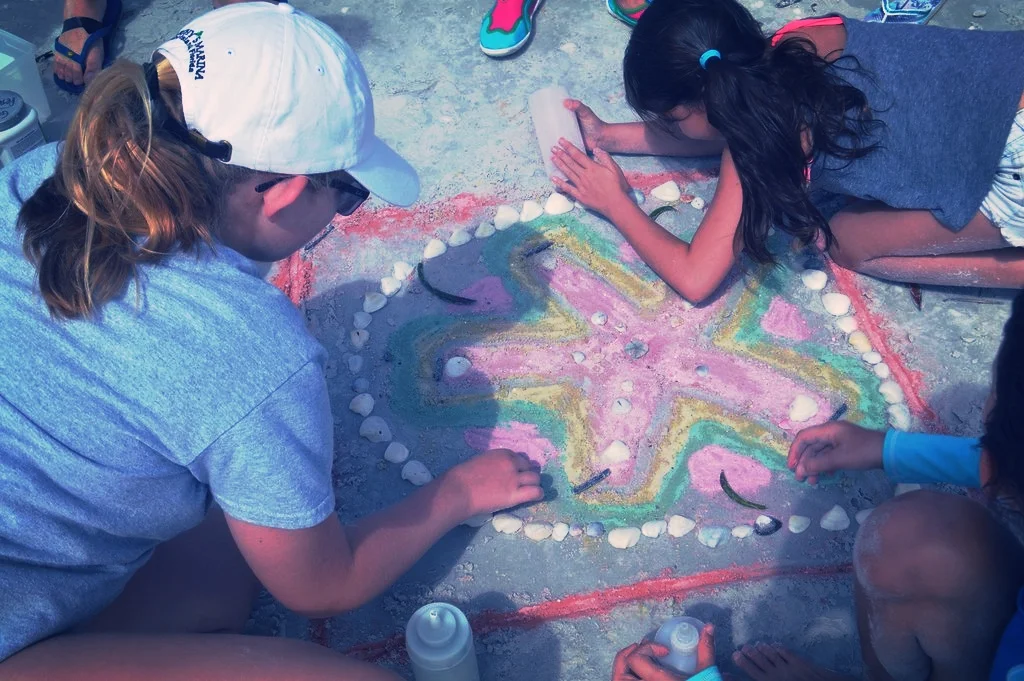 Campers created a sand dollar-inspired mandala on the beach.