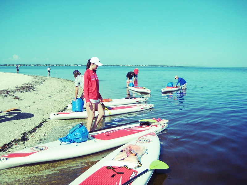 Have Paddleboard, Will Survive campers arrive at Picnic Island for an overnight test of their survival skills. 