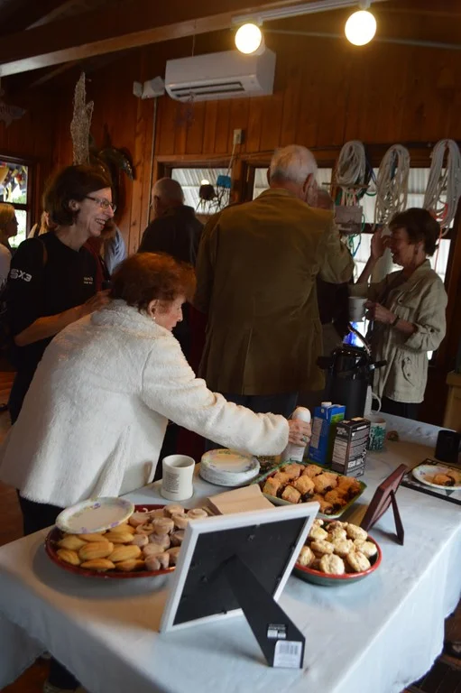 Attendees enjoy coffee and pastries in the Richard C. Kennedy Building. 