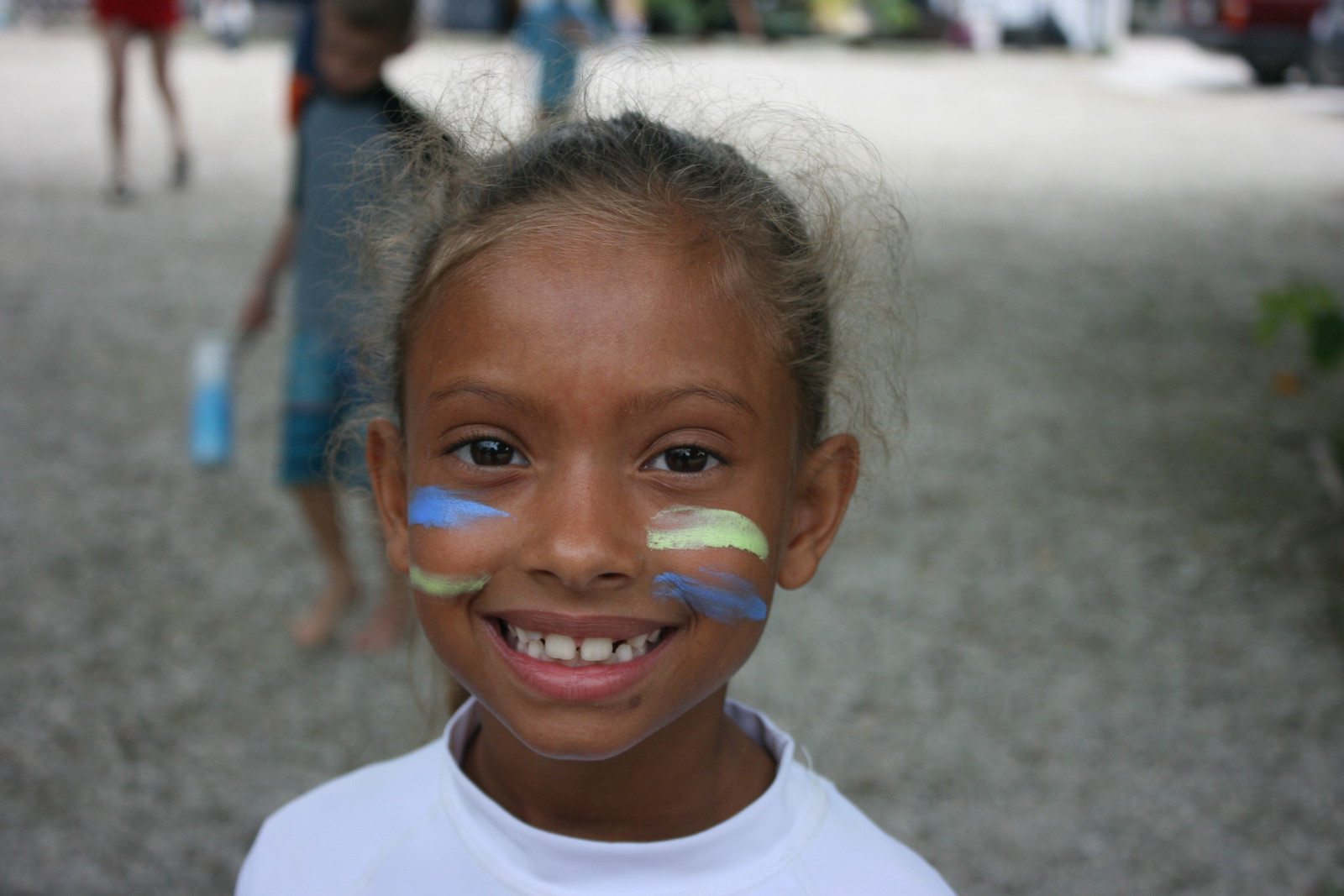 Campers showed their team spirit with face paint in their surfboard paddling team colors. 