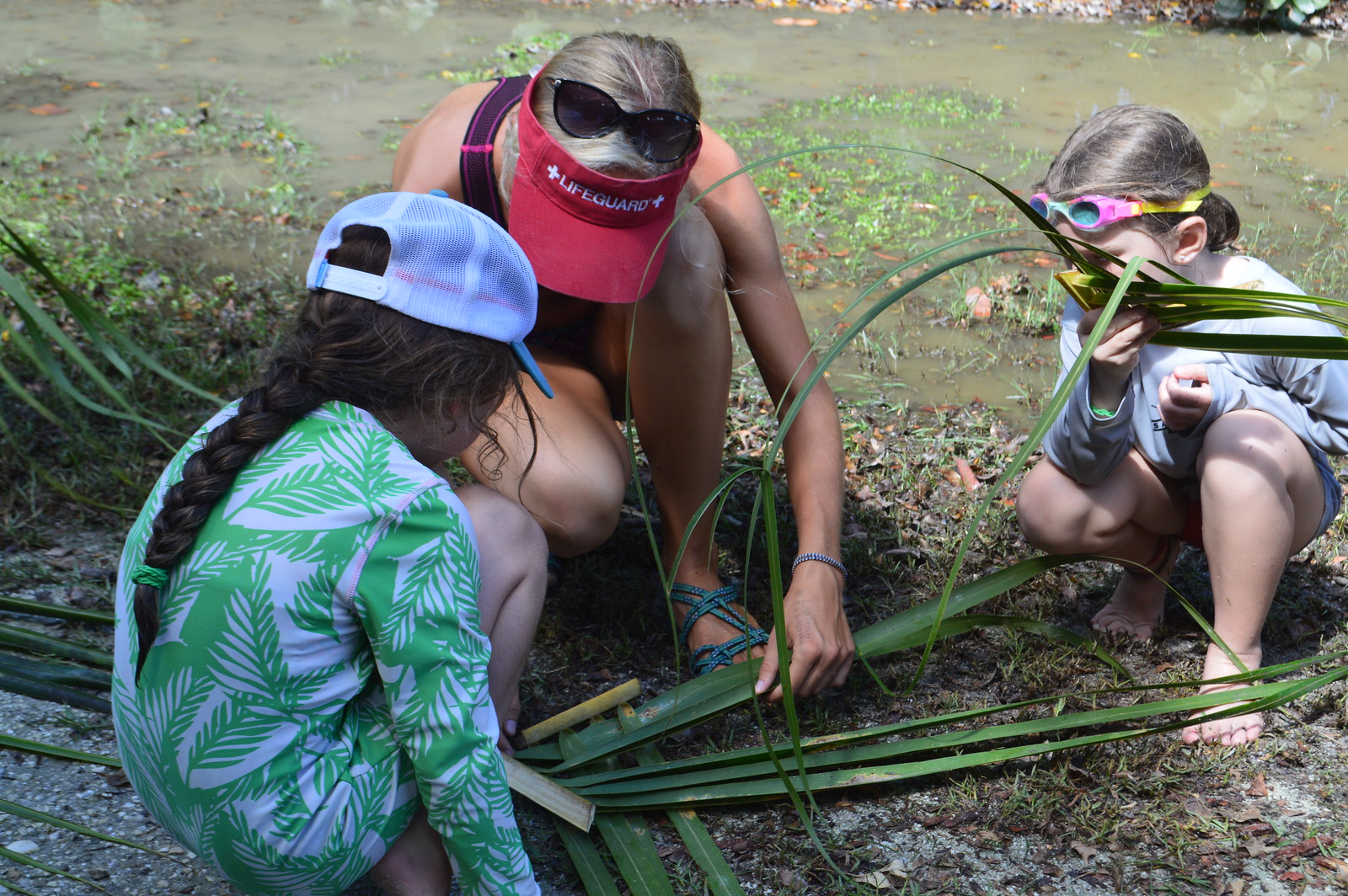 Campers practiced weaving plates from palm fronds. 
