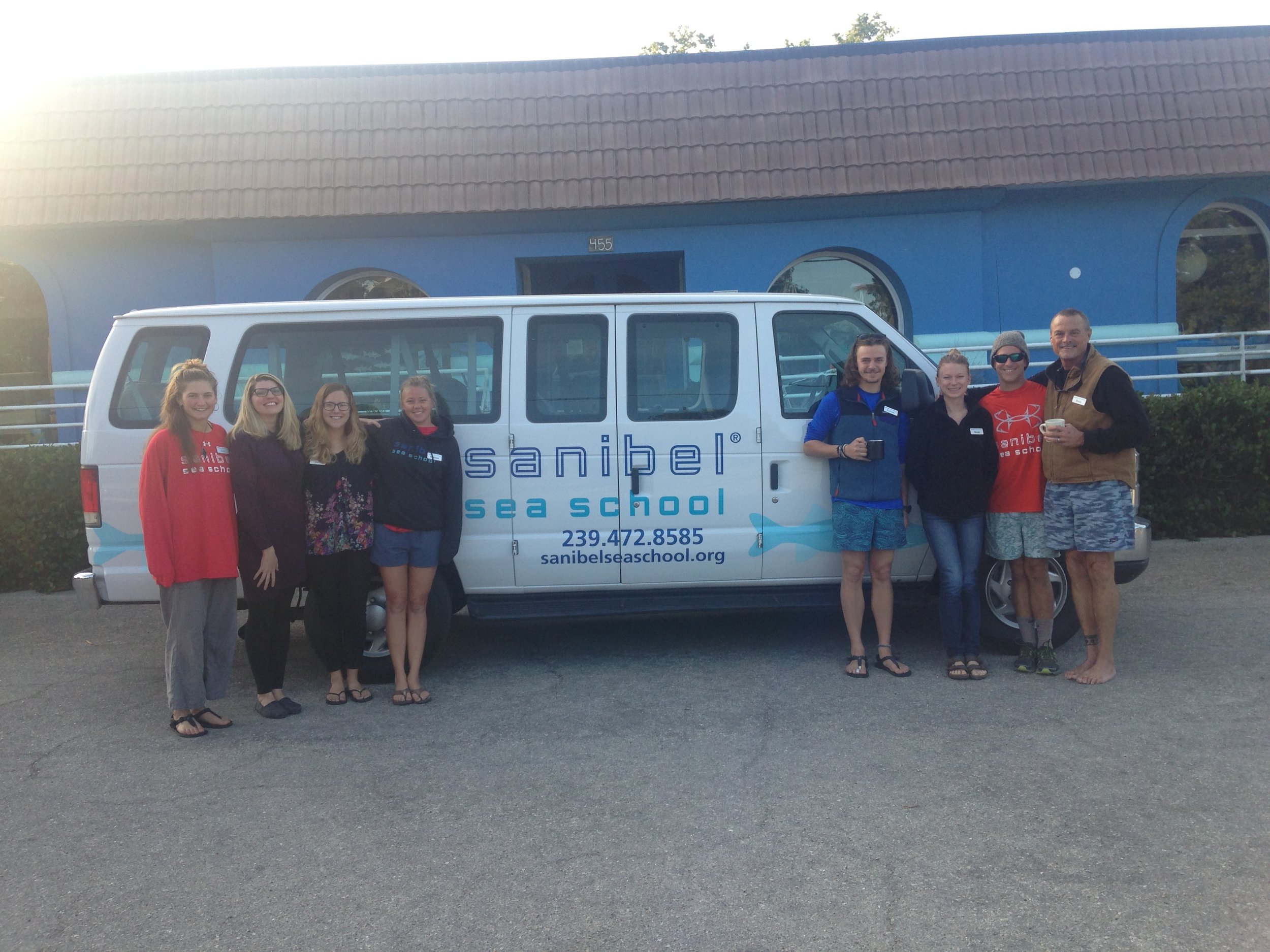 Sanibel Sea School staff members Char Cadow, Christina Gould, Sam Lucas, Shannon Stainken, Emmett Horvath, Nicole Finnicum, Johnny Rader, and Bruce Neill pose for a photo with one of the organization's new vans.