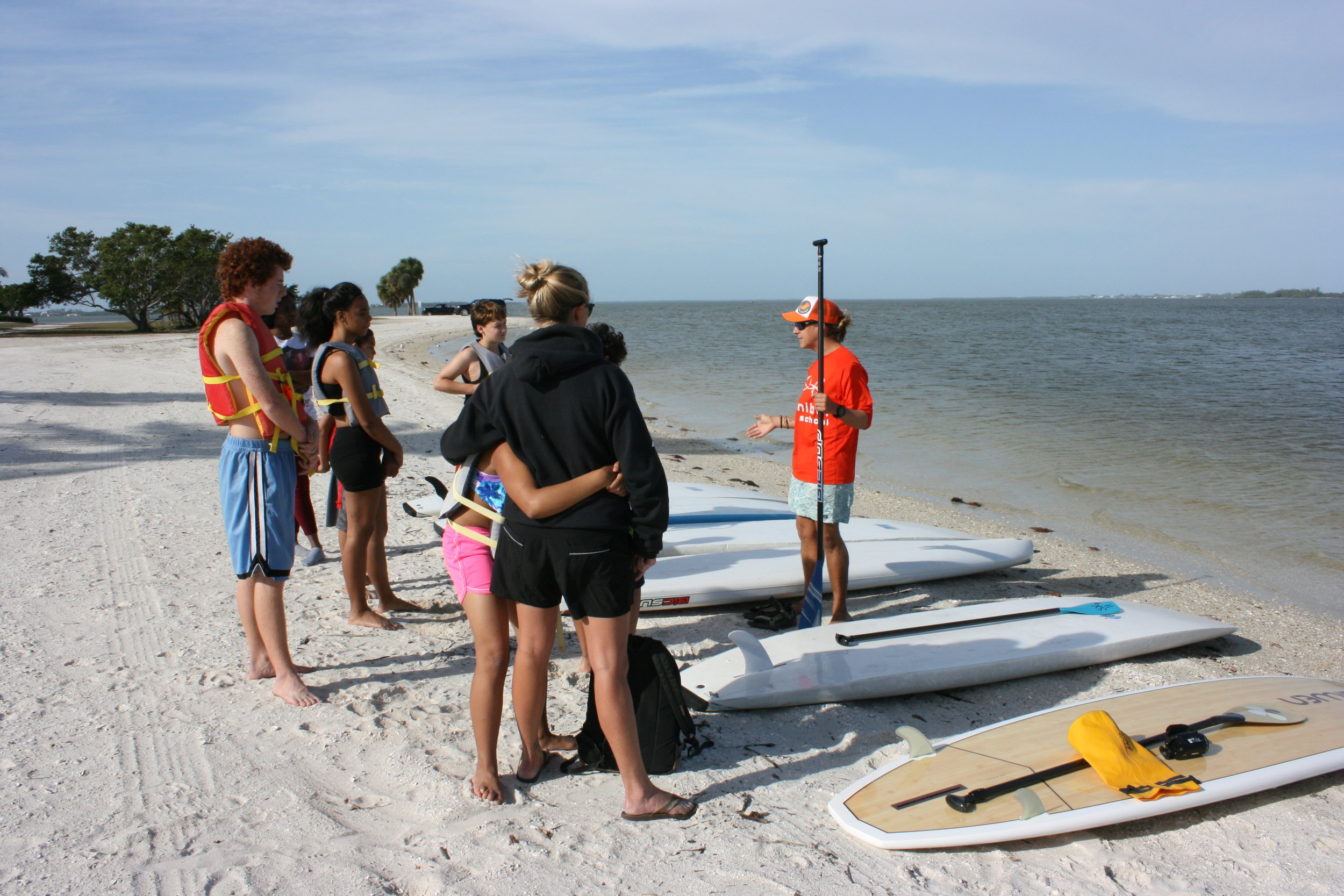 Participants prepared for a stand up paddleboarding lesson.&nbsp;