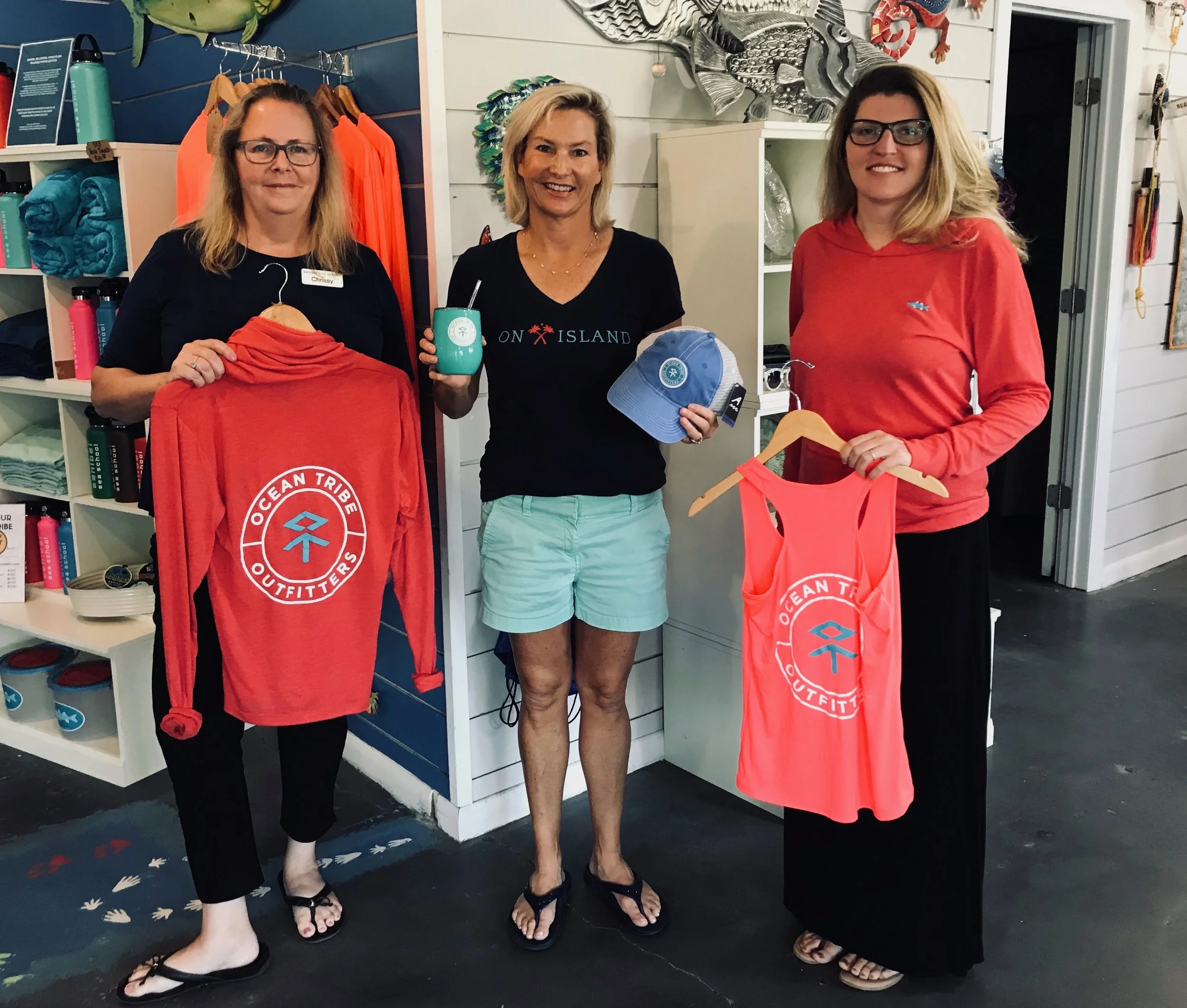 Chrissy Basturk, Kate Sergeant, and Christina Gould display some of the new items available at Sanibel Sea School’s Ocean Tribe Outfitters.