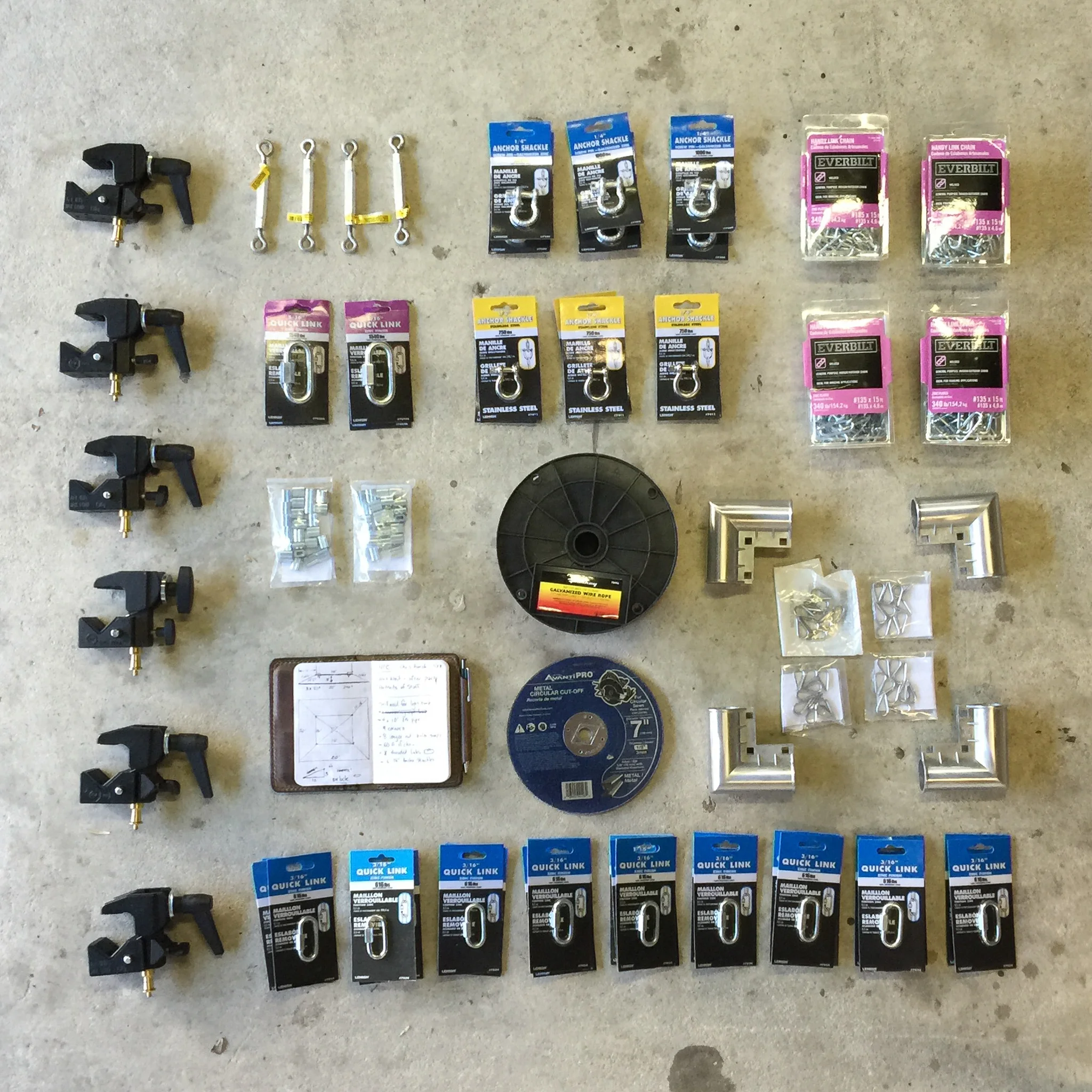 Things arranged neatly (sort of). This is most of the parts needed (but not all). Also, not pictured are the twelve 10' pipes and the 400 sq ft white silk panel.