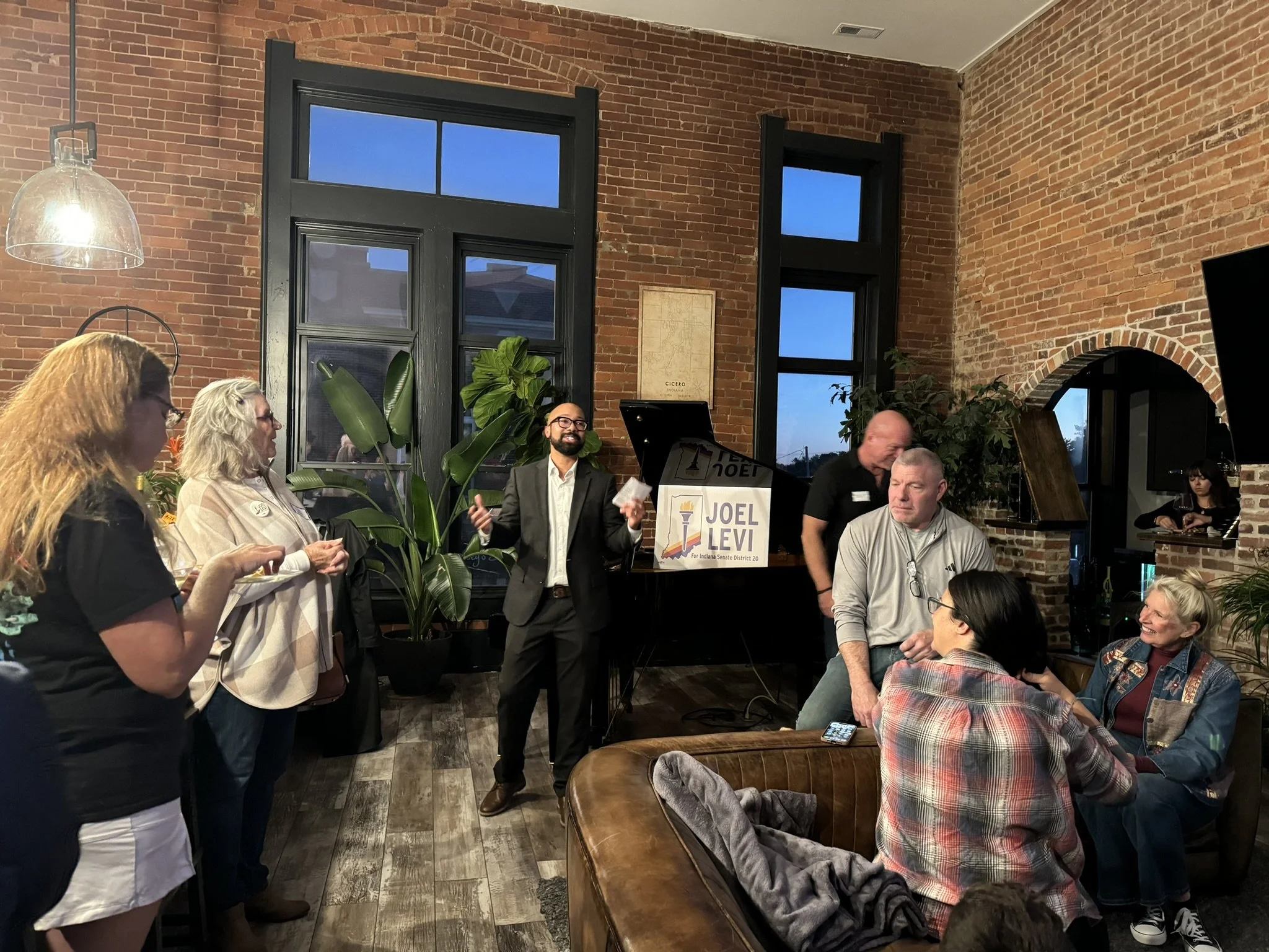 Joel Levi talks to constituents at a house party.