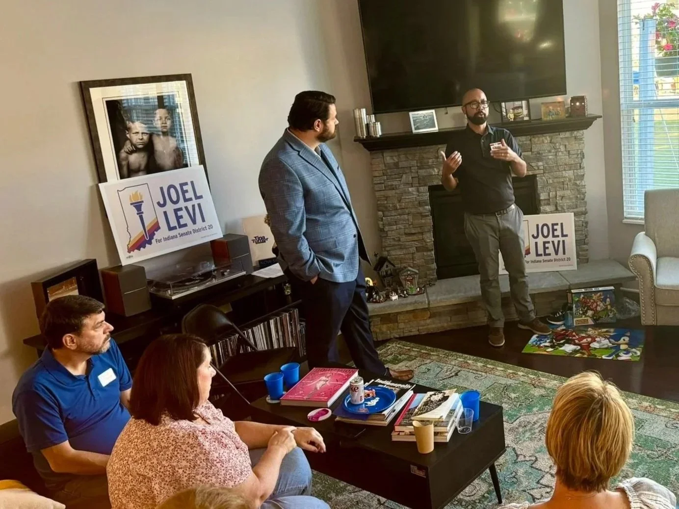 Joel Levi talks to constituents at a house party.