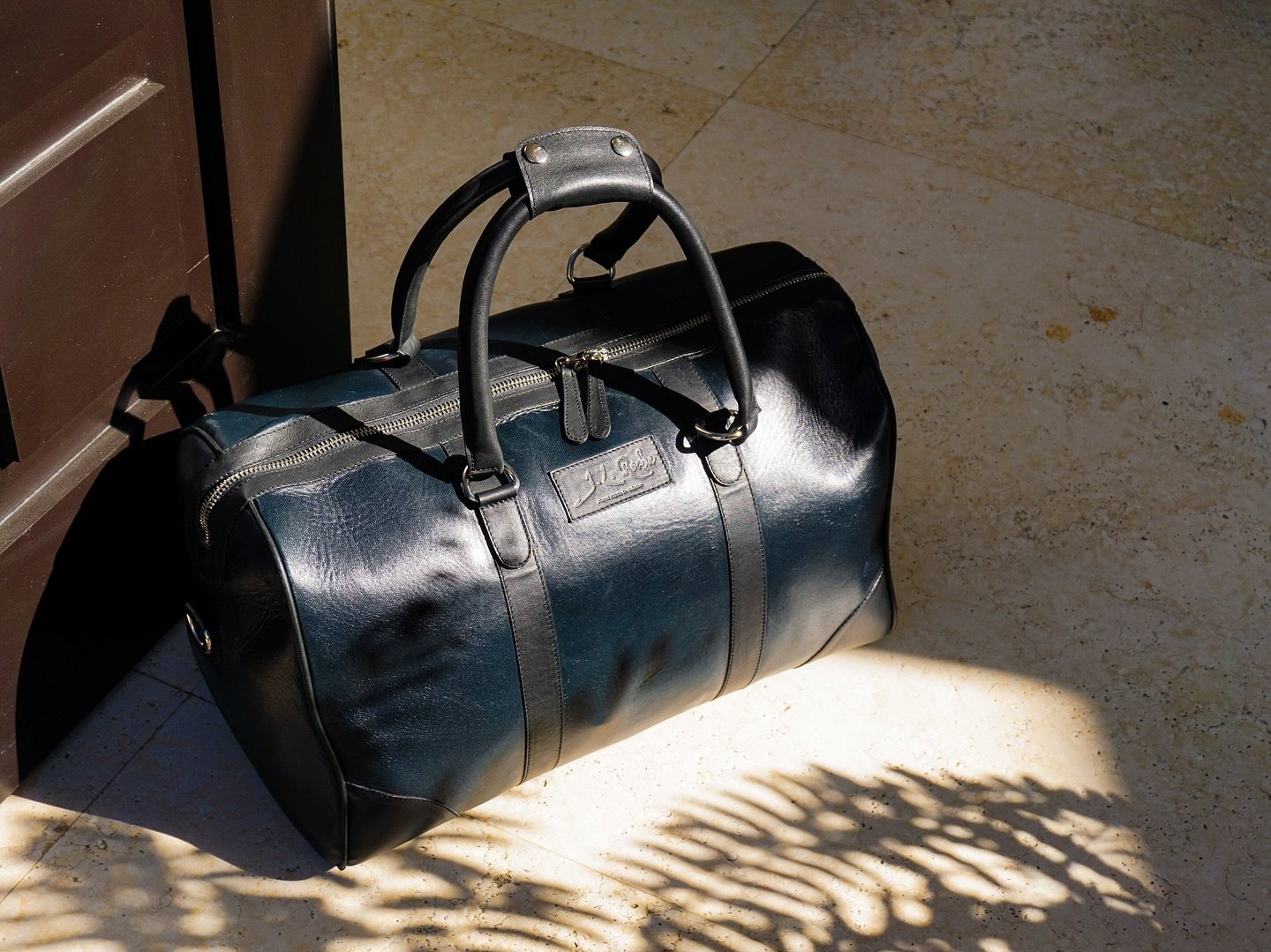 The isla duffel bag in full grain lambskin leather. 

Pigmented in our unique aniline petrol blue and black, creating this unique and detailed midnight blue. 

Aniline leather is a type of leather dyed exclusively with soluble dyes. The dye colours t