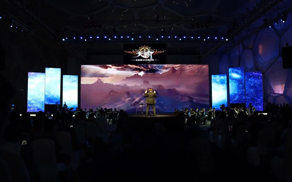 Neal Acree conducts music from Revelation Online in Beijing