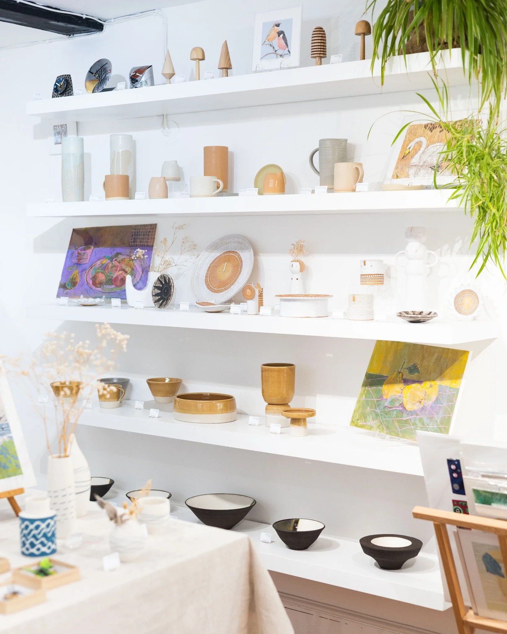 Our shelves are looking lovely with complementary shades of yellow and purple! The middle shelf features new pieces from Atelier Stella Ceramics who's whimsical sunny designs and characters look beautiful next to Carolina Rabei's mixed media pieces. 
