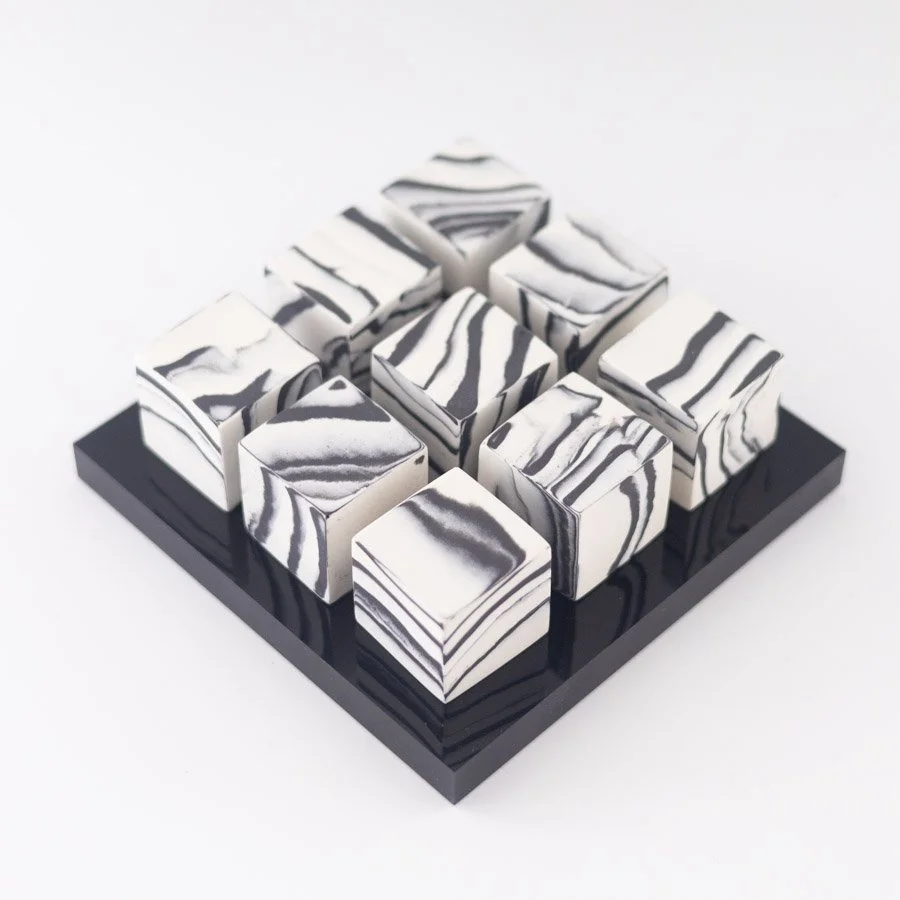 9 Small Cubes on Black Perspex Plinth by Kim Colebrook
