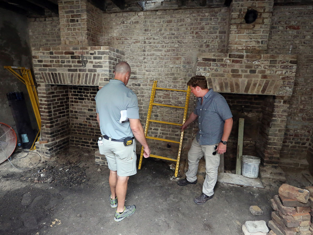 Kevin O'Connor, host of "This Old House" talks with Andy Meihaus of Renew Urban about the renovation of the Ansonborough home. Brad Nettles/Staff. Brad Nettles bnettles@postandcourier.com
