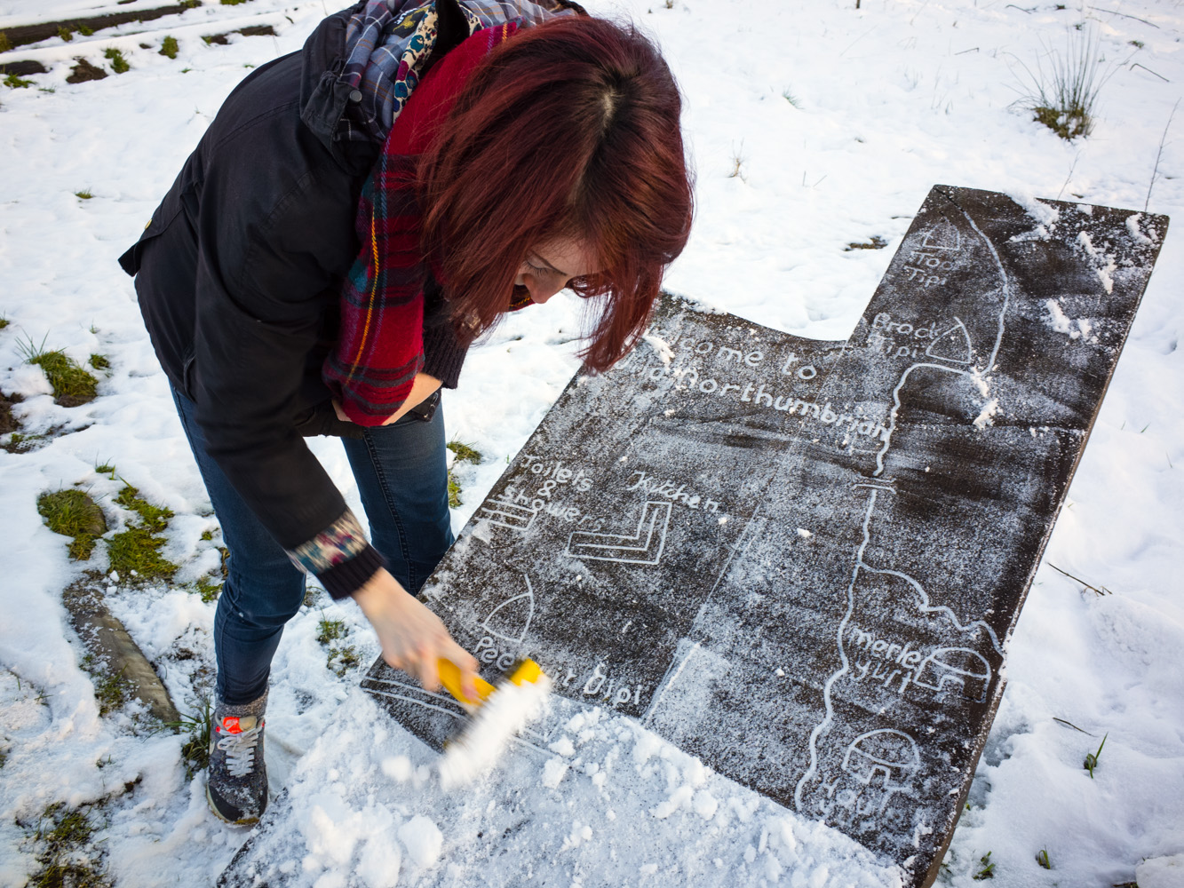 Scraping snow and ice off the site map to find out where our accommodation was.