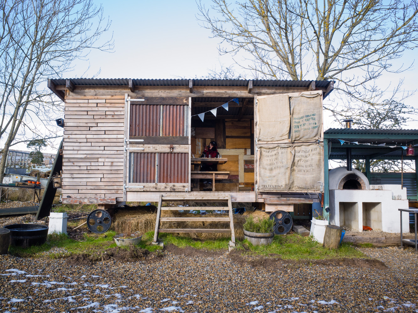 A dining wagon next to an outdoor kitchen on site. This would be lush during the summer!