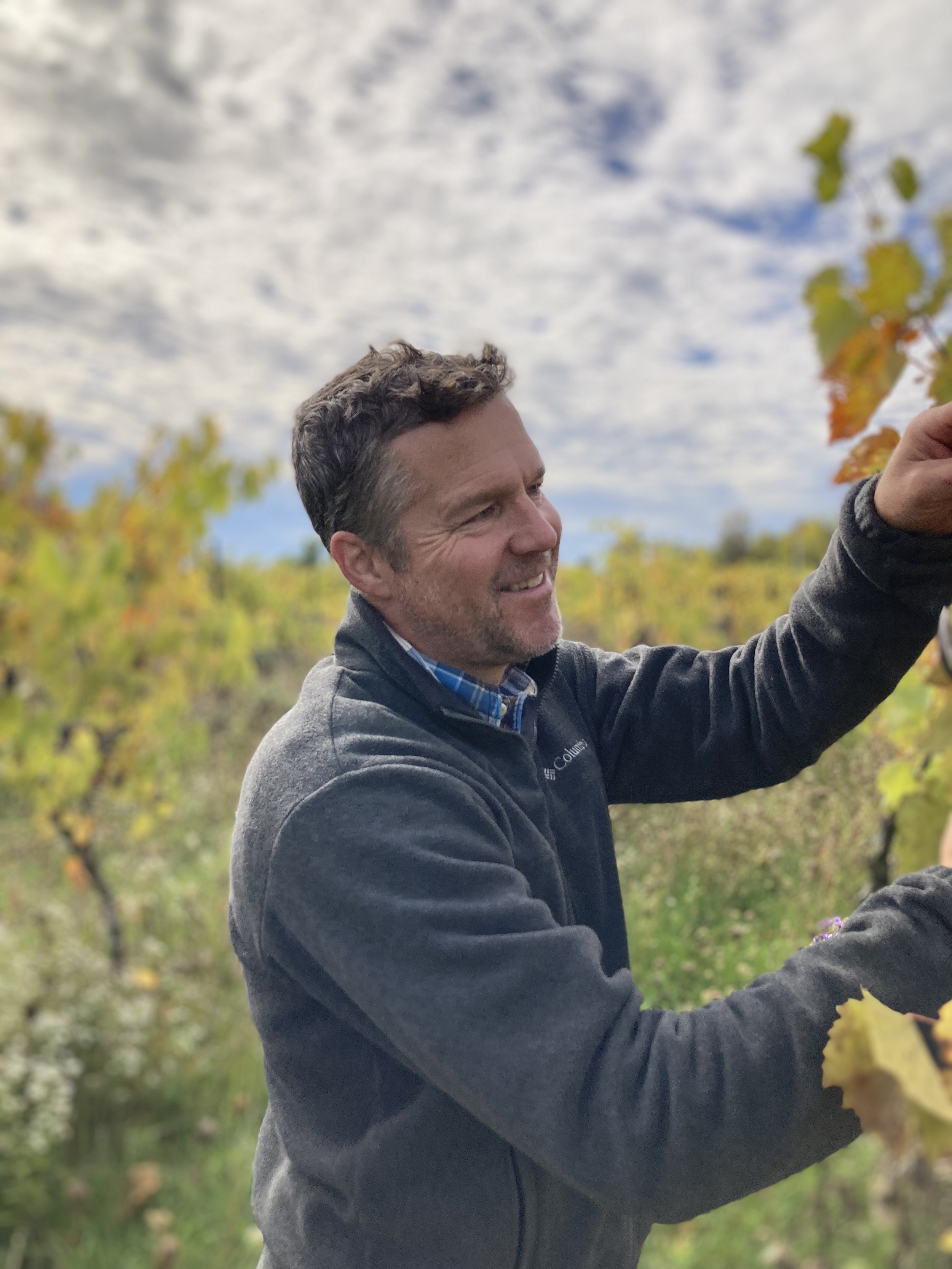 photo of Caleb in Vergennes vineyard 2023 harvest.jpg