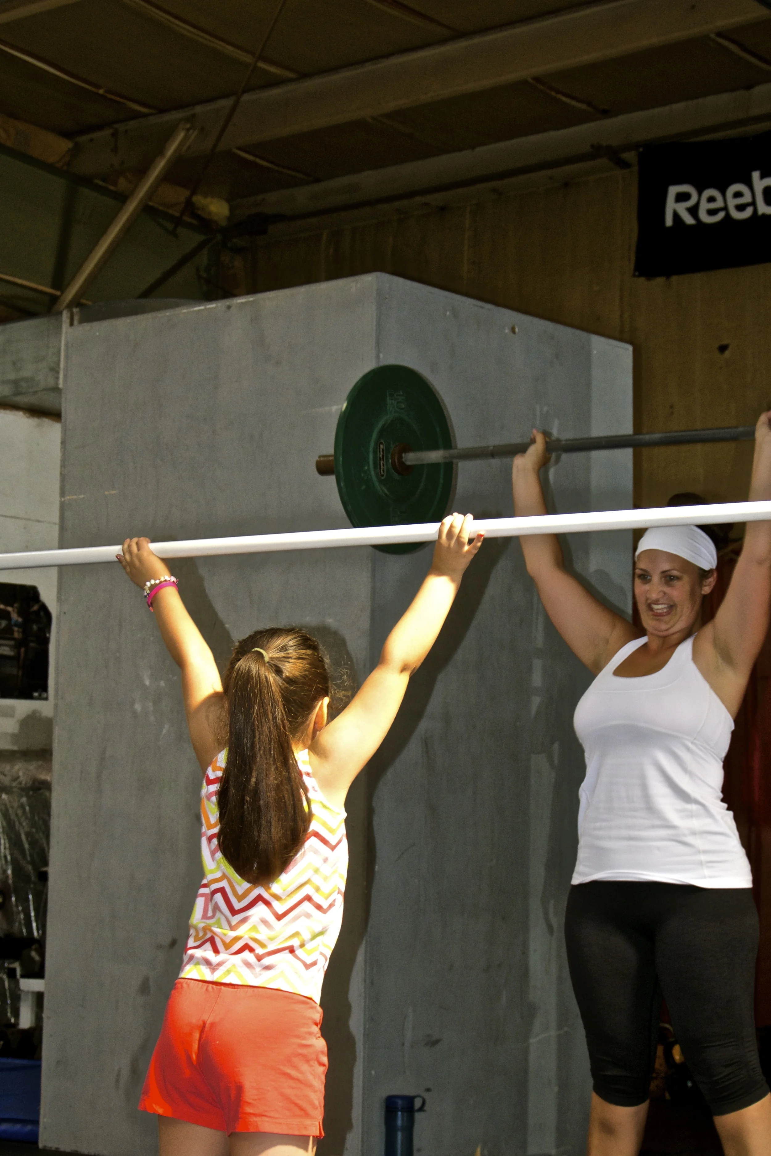 Page and Izzy practice shoulder presses. 