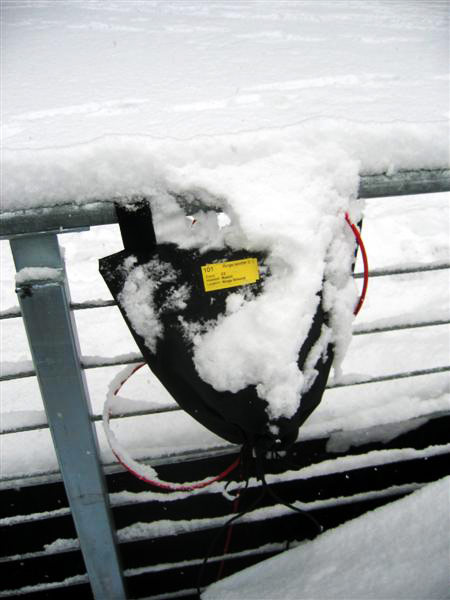 Pete Erskine designed storage bags for the outdoors equipment. The bags opened at the bottom and were fastened with Velcro at the top. This allowed humidity to escape and wires to stay attached to the beltpacks. Here's one after the first snowstorm.