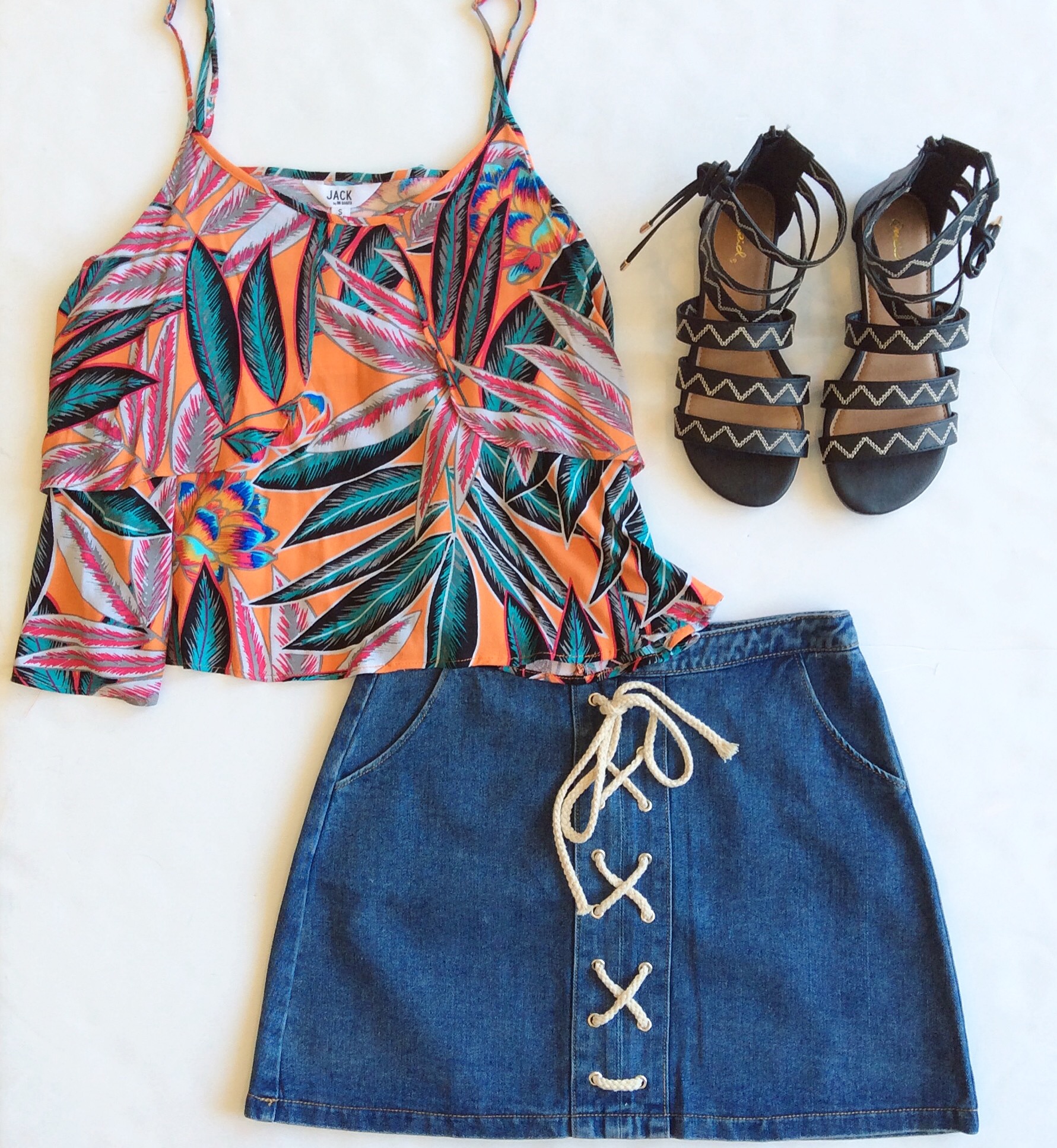 A denim skirt is a must-have of the season. This one features trend-right lace up detailing and a length that makes it a great shorts alternative. Paired with a summer-print top & flat sandal, you're vacay ready!