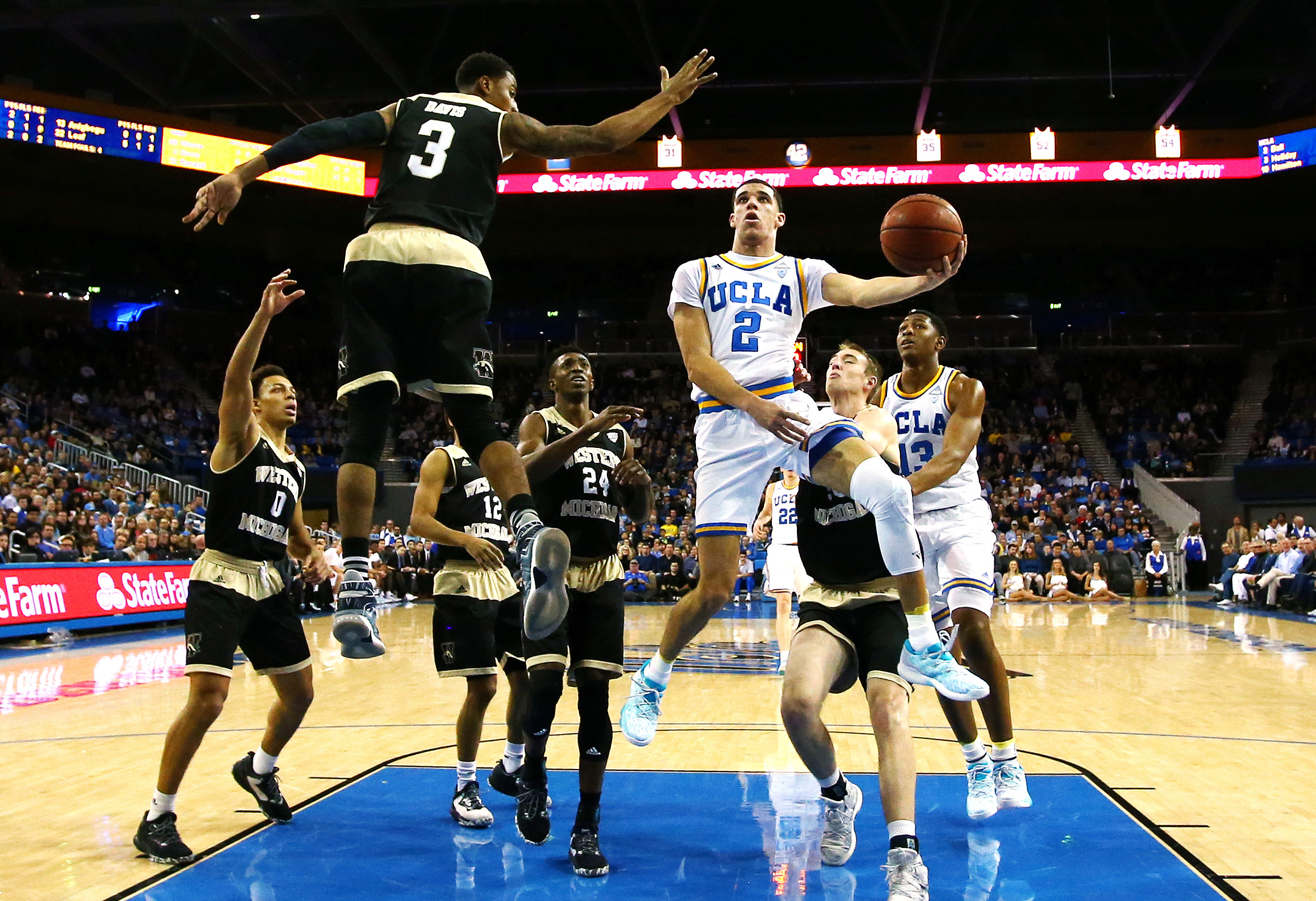 LOS ANGELES, CA - DECEMBER 21: Lonzo Ball #2 of the UCLA Bruins drives to the basket against Josh Davis #3 of the Western Michigan Broncos during the first half of their game at Pauley Pavilion on December 21, 2016 in Los Angeles, California. (Photo by Tim Bradbury/Getty Images)
