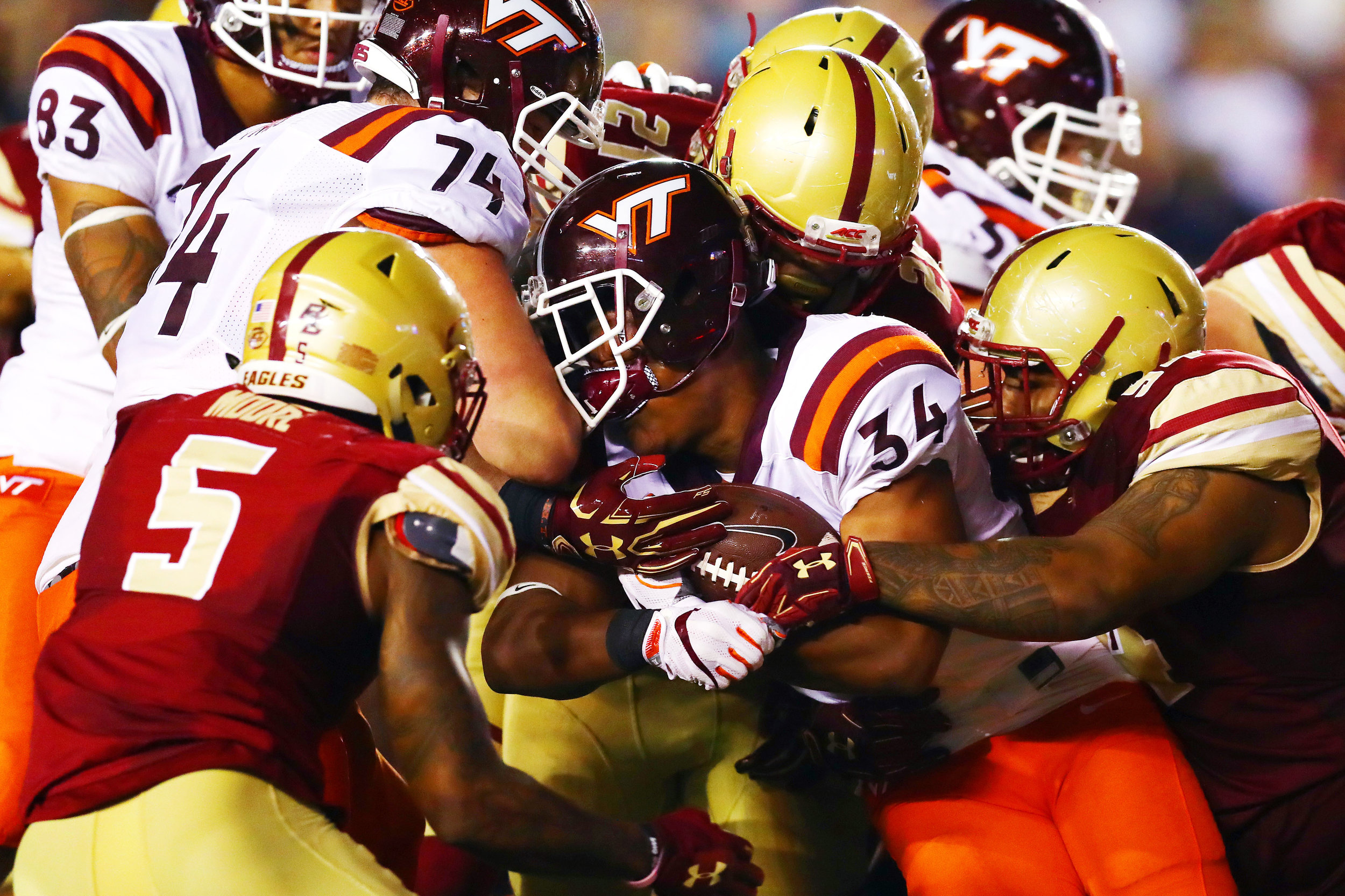 CHESTNUT HILL, MA - OCTOBER 07: Travon McMillian #34 of the Virginia Tech Hokies loses his helmet as he is tackled by the Boston College Eagles defense during the first half at Alumni Stadium on October 7, 2017 in Chestnut Hill, Massachusetts. (Photo by Tim Bradbury/Getty Images)