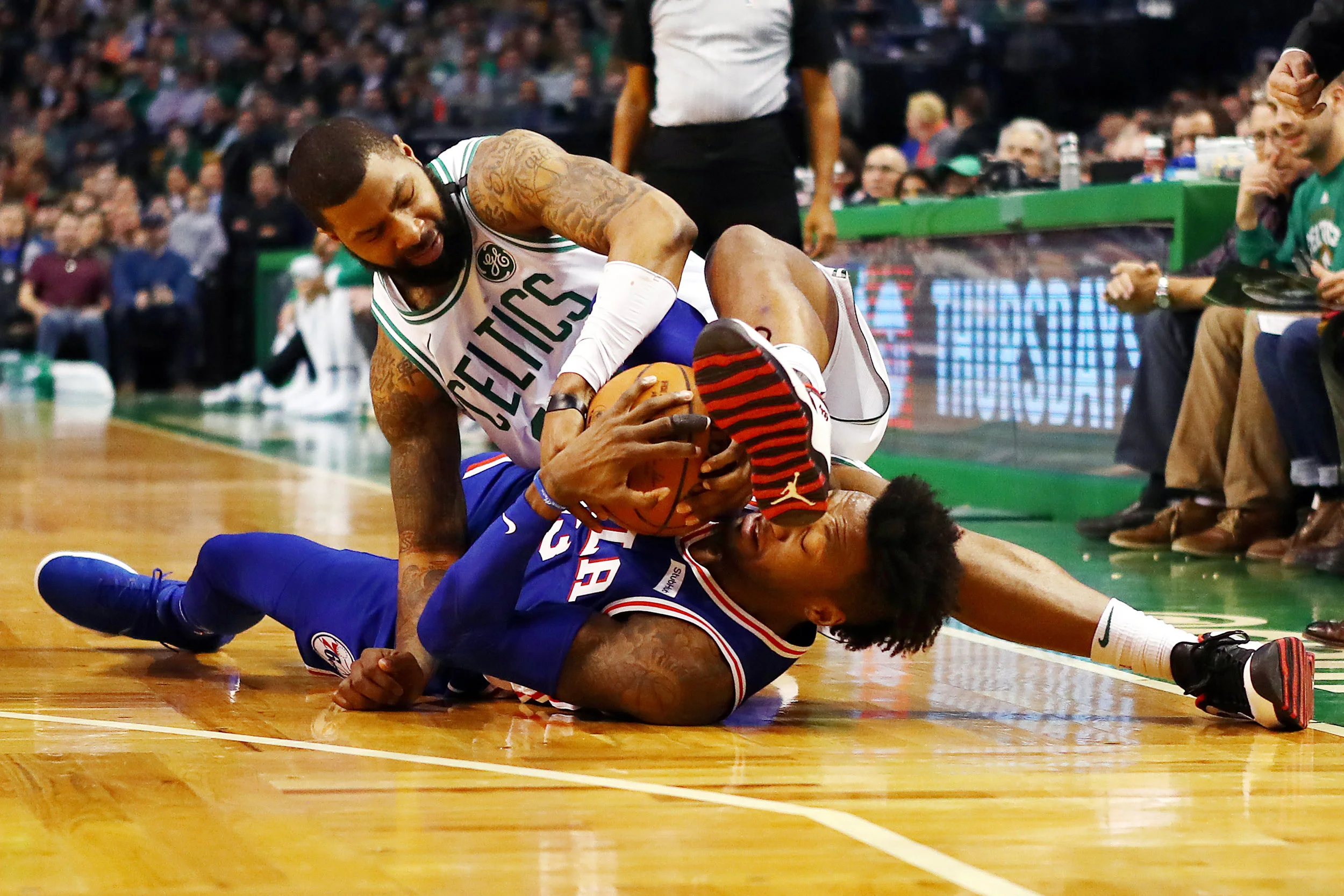 BOSTON, MA - JANUARY 18: Robert Covington #33 of the Philadelphia 76ers and Marcus Morris #13 of the Boston Celtics battle for a loose ball during the first half of their game at TD Garden on January 18, 2018 in Boston, Massachusetts. (Photo by Tim Bradbury/Getty Images)