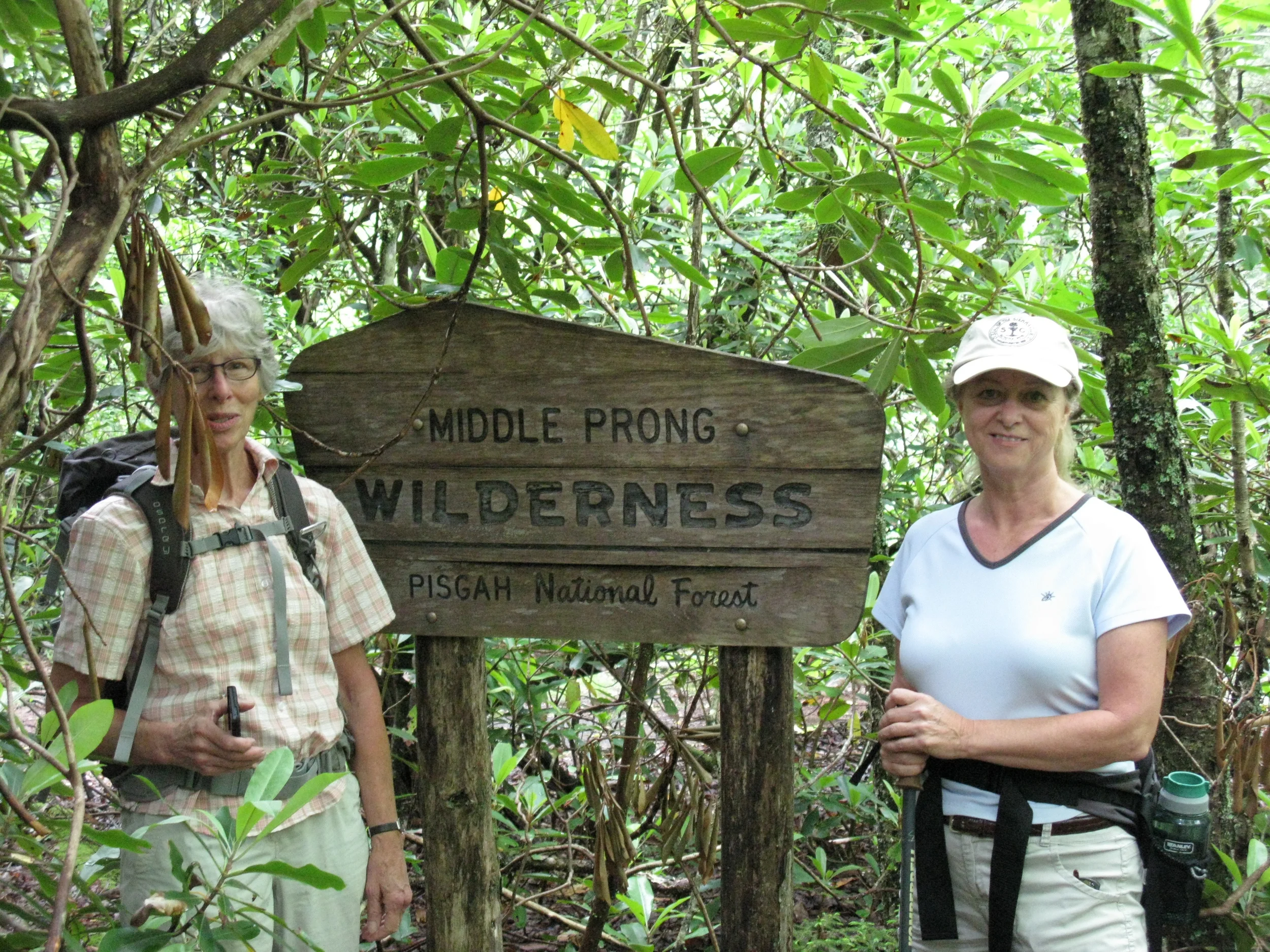 Maribeth Weinman (left) and Linda McCorkindale pose alongside the Middle Prong Wilderness sign.