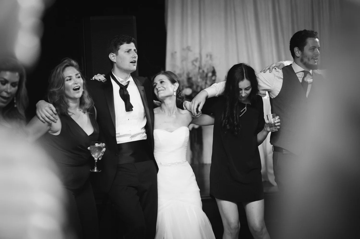 last dance of a black tie wedding all guests arm in arm on the dance floor