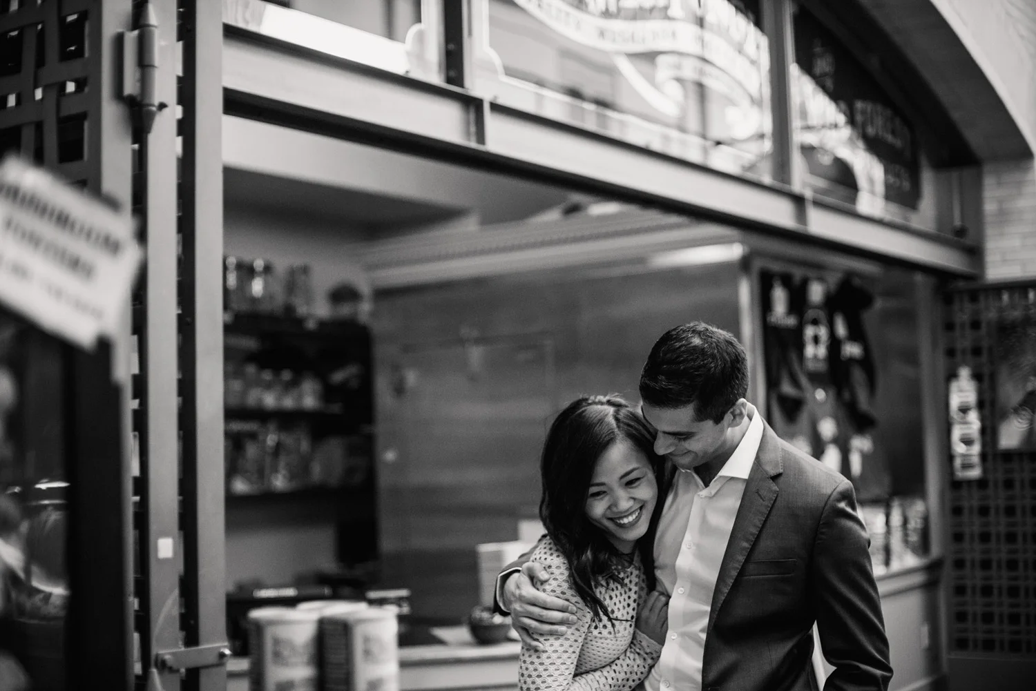 natural engagement photograph couple hugs in the ferry building in San Francisco
