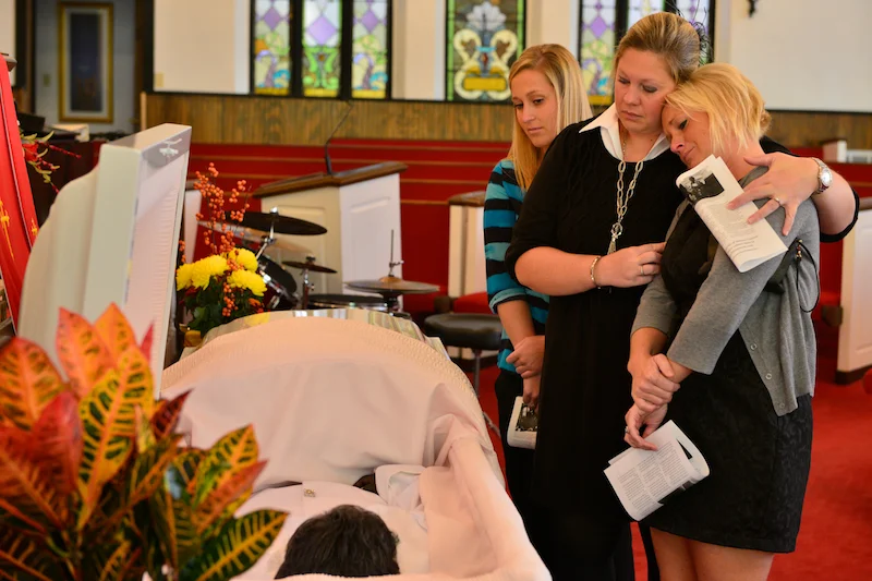 Miranda Chapin, left, and Lindsey Sell, center, comfort Megan Sievers, right, on November 1, 2013 at the public viewing and memorial service for Almeta Crayton at Second Missionary Baptist Church. Crayton was a council member and community activist.